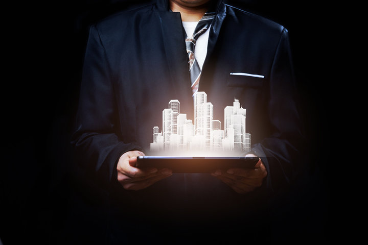 um homem com uum prédio apresentado no tablet em 3d demonstrando a valorização do imóvel após a reforma
